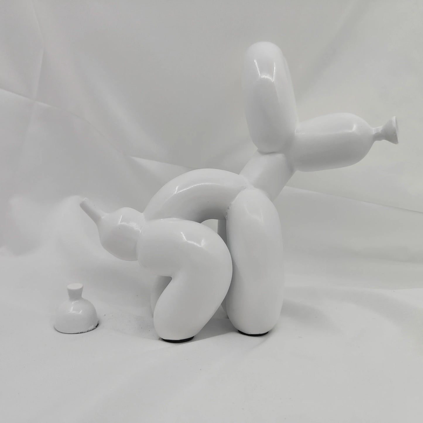 Artistic resin dog novelty figurine with playful design.