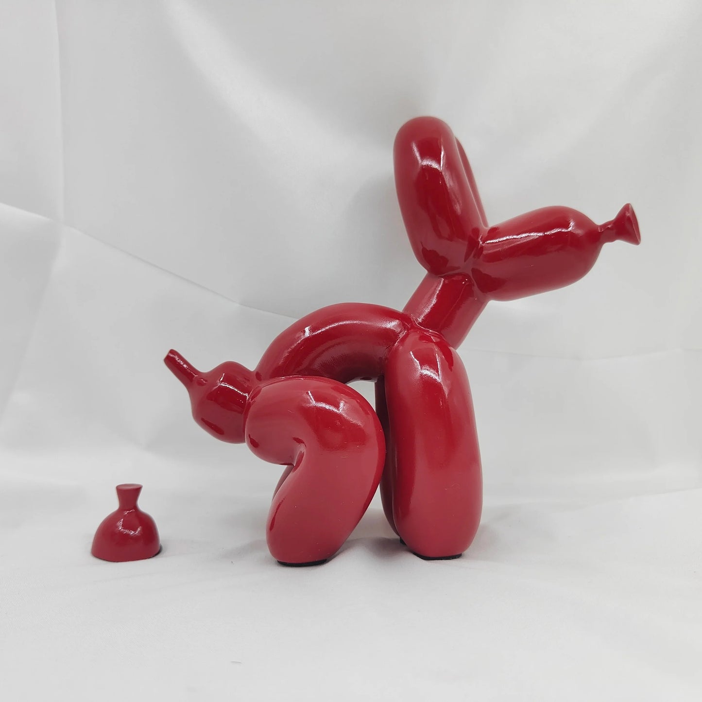 Durable resin pooping dog collectible with realistic finish.