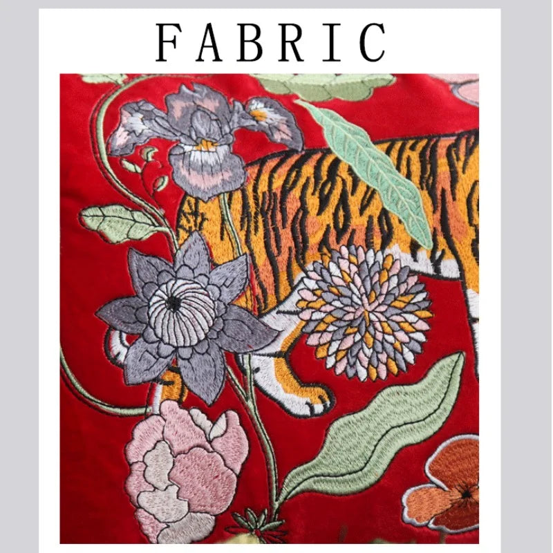 Close-up of tiger embroidered red velvet pillow cover.