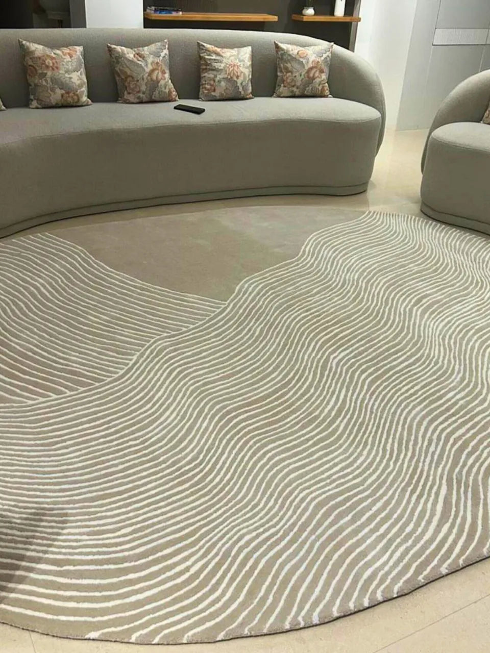 Designer oval area rug with flowing white lines and neutral base.