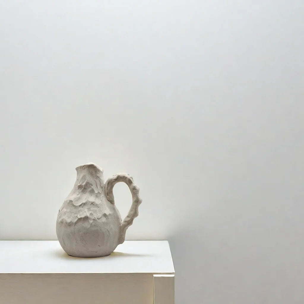 Rustic handmade ceramic pitcher vase for tabletop styling.