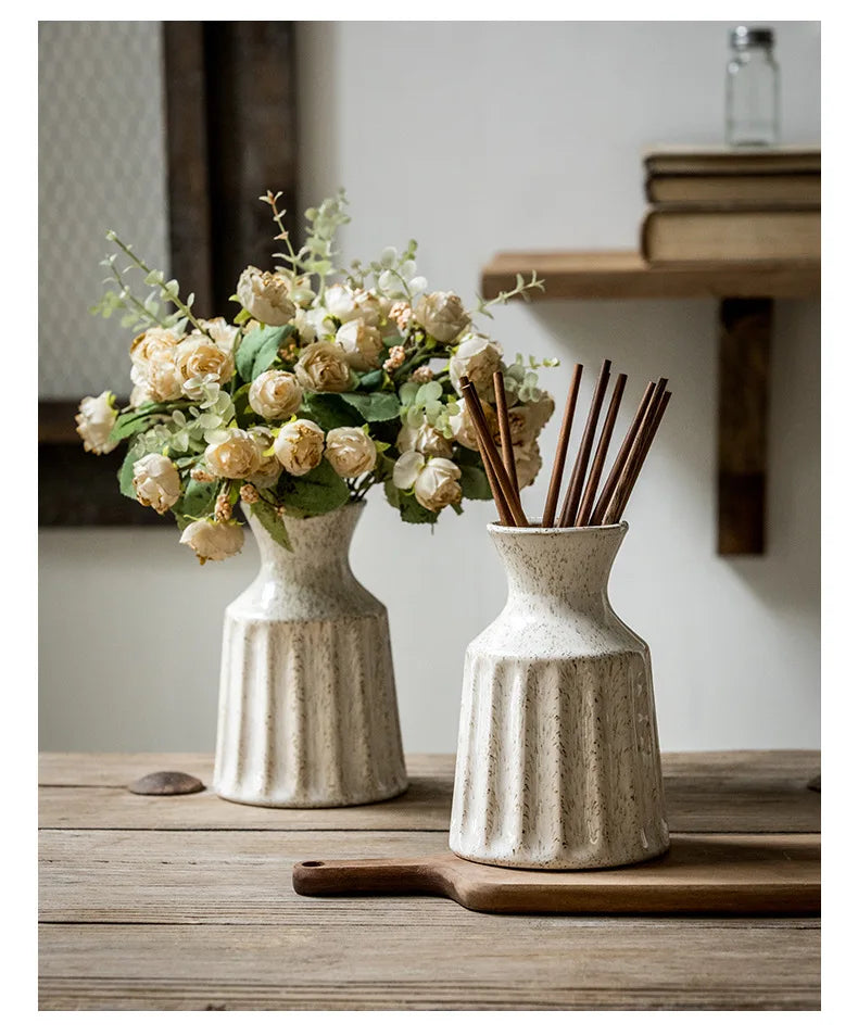 Decorative ceramic vase with vertical fluted texture.