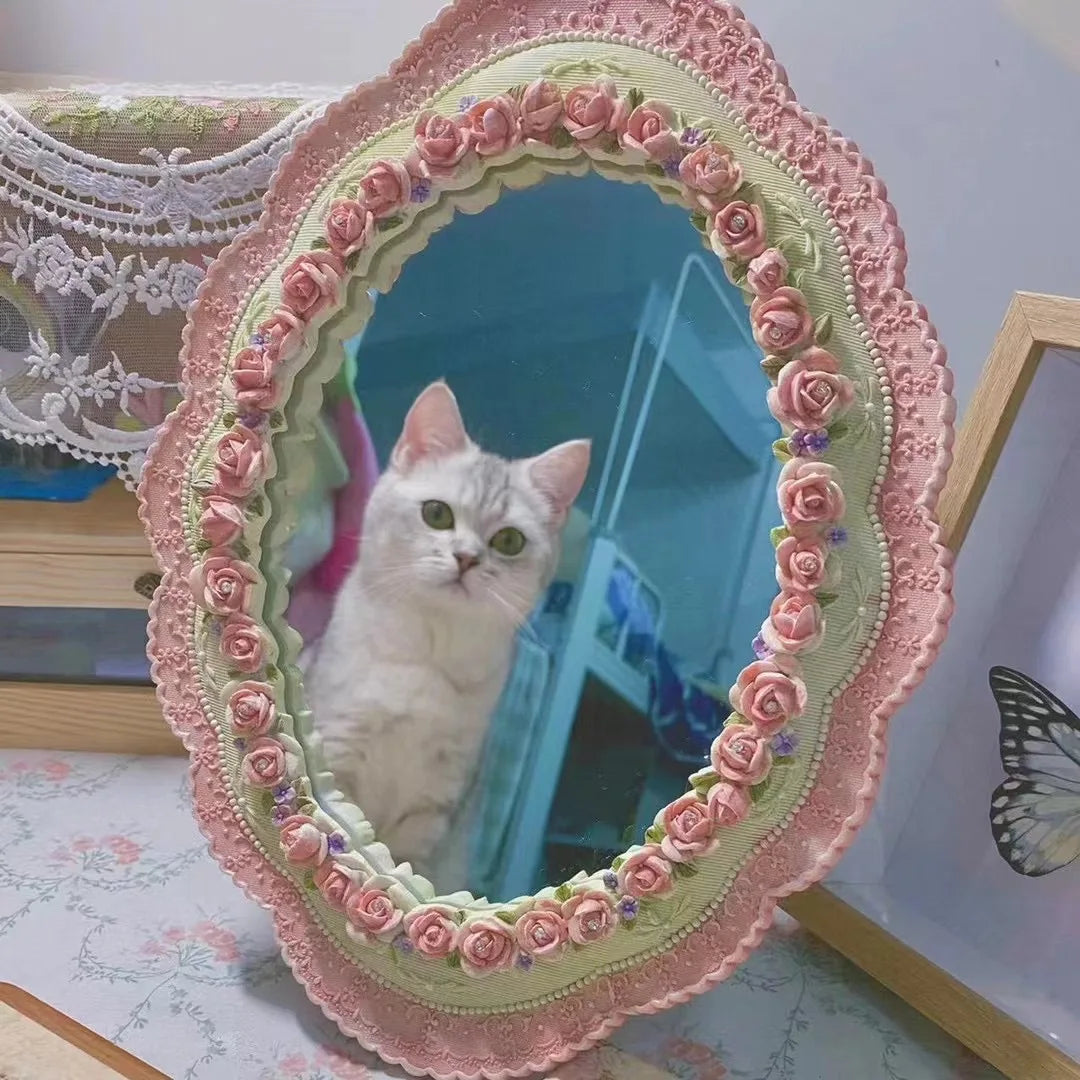 Retro-style pink mirror for bedroom or dressing area.