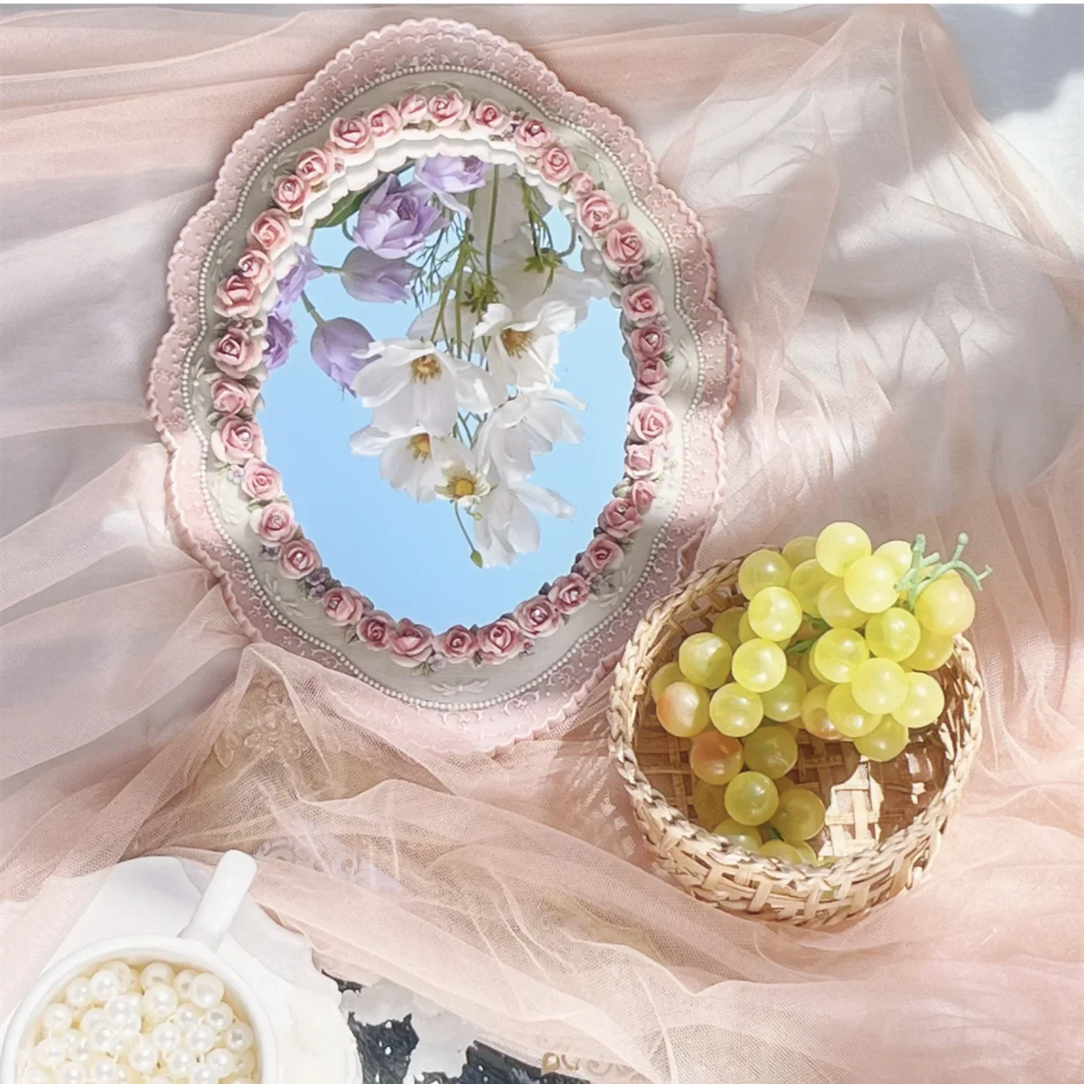 Artistic pink wall-mounted mirror for classic home décor.