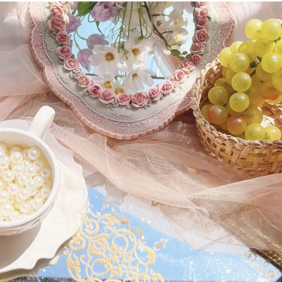 Shabby chic oval mirror with handcrafted rose accents.